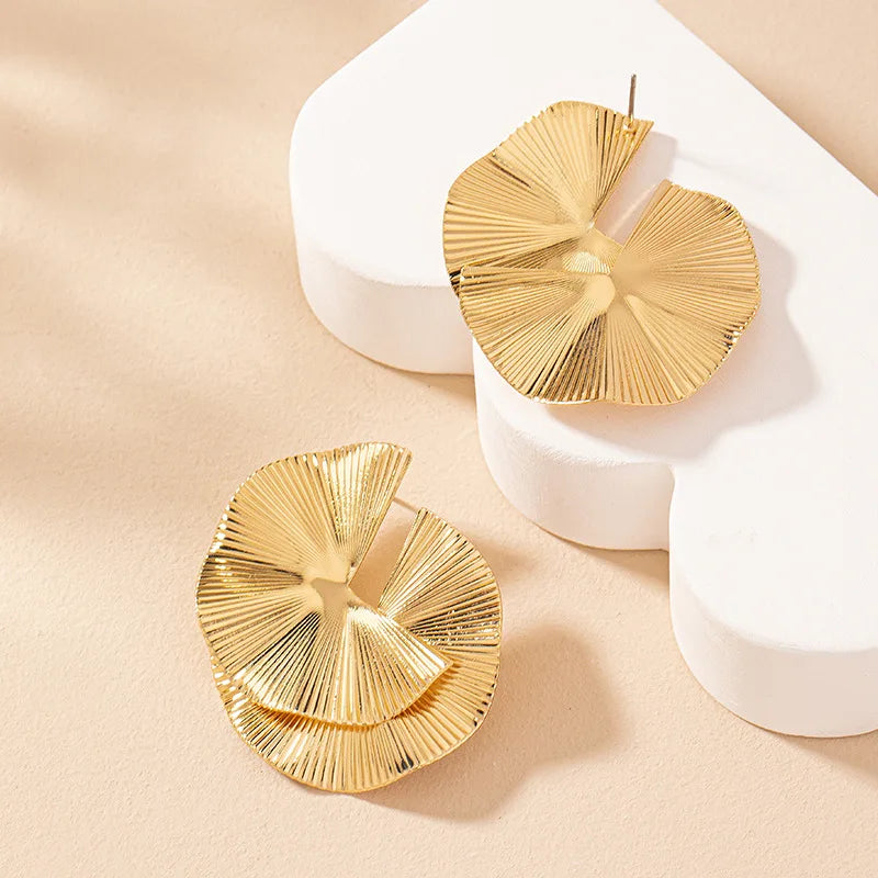 Boucles d’oreilles Mnémé dorées, accessoire sculptural et raffiné, idéal pour une touche contemporaine et artistique.