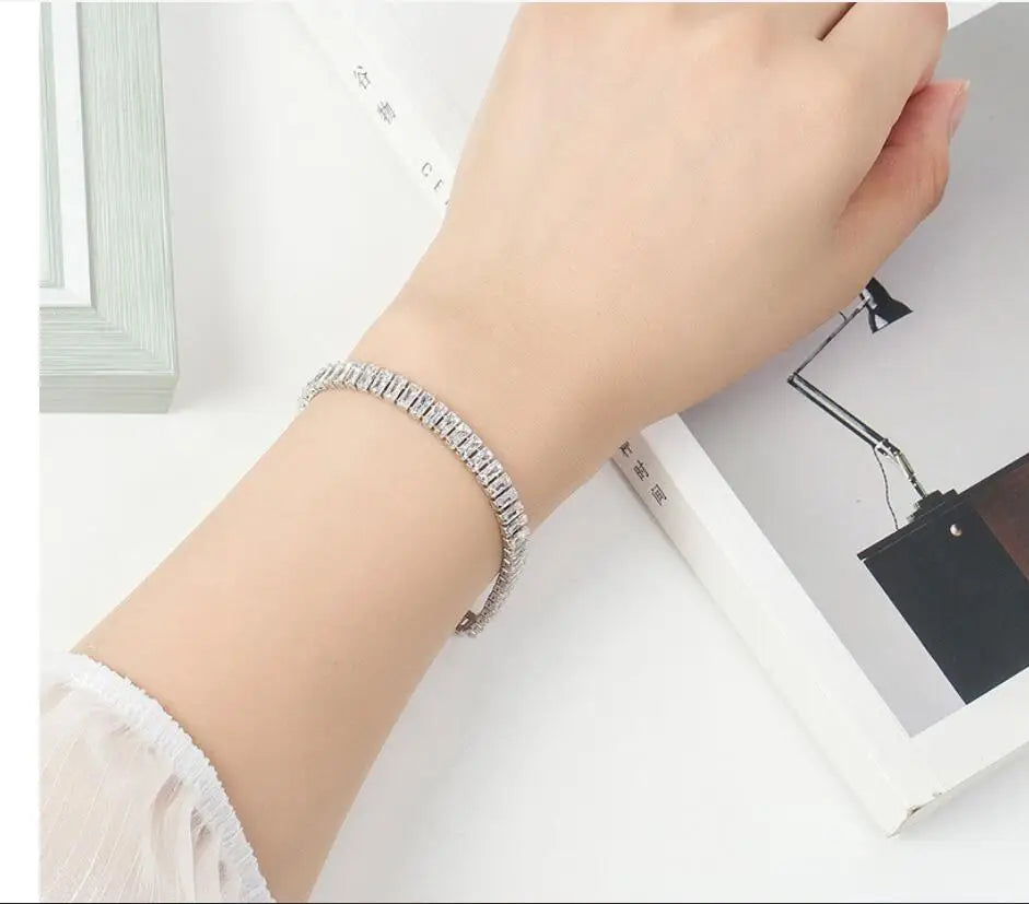 Bracelet jonc Harmonia argenté en acier inoxydable, orné de milliers de brillants étincelants, porté pour un look glamour et sophistiqué.