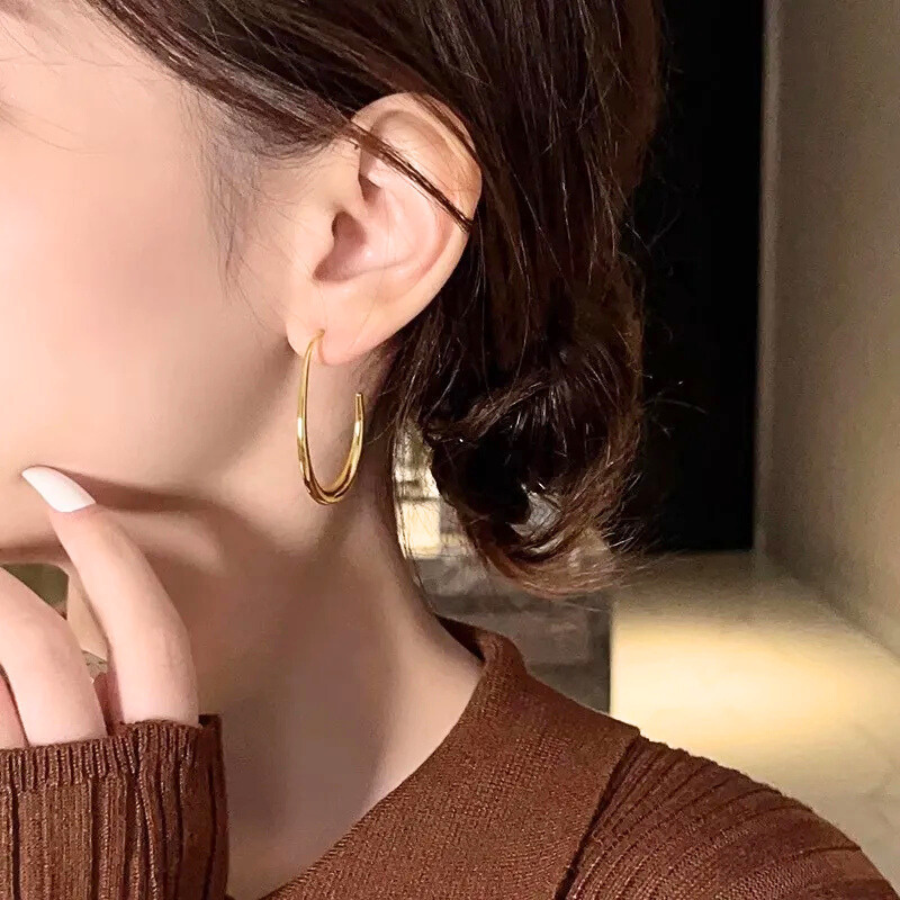 Boucles d’oreilles Erato en acier inoxydable doré, créoles ovales élégantes et modernes, bijou raffiné et intemporel.