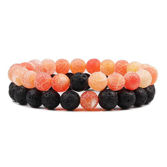 Duo de bracelets Énergie en pierre naturelle orange et noire, symbole de vitalité et de puissance.