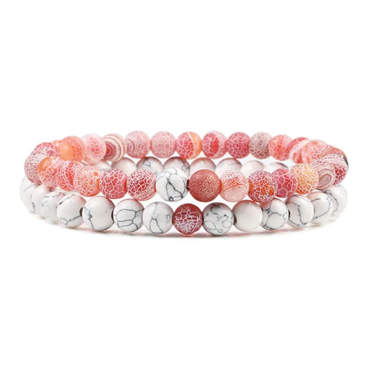 Duo de bracelets Élégance Suprême en pierre naturelle rose et blanche, symbole d’harmonie et de raffinement.