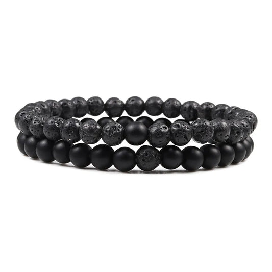 Duo de bracelets Équilibre en pierre naturelle noire, avec perle en pierre de lave brute et perle polie, symbole de force et d’élégance.