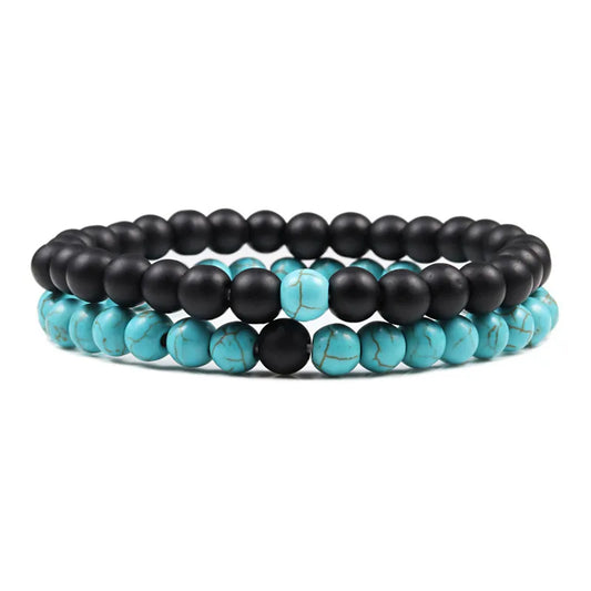 Duo de bracelets Mystique en pierre naturelle noire et bleu/vert veiné, symbole de sérénité et de force intérieure.