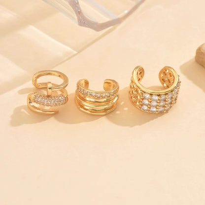 Lot de 3 boucles d’oreilles ear cuff dorées en acier inoxydable – design raffiné avec petits brillants.