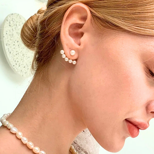 Boucles d’oreilles Phaédria en acier inoxydable doré, design épousant le contour de l’oreille avec perles lumineuses, bijou élégant et raffiné.